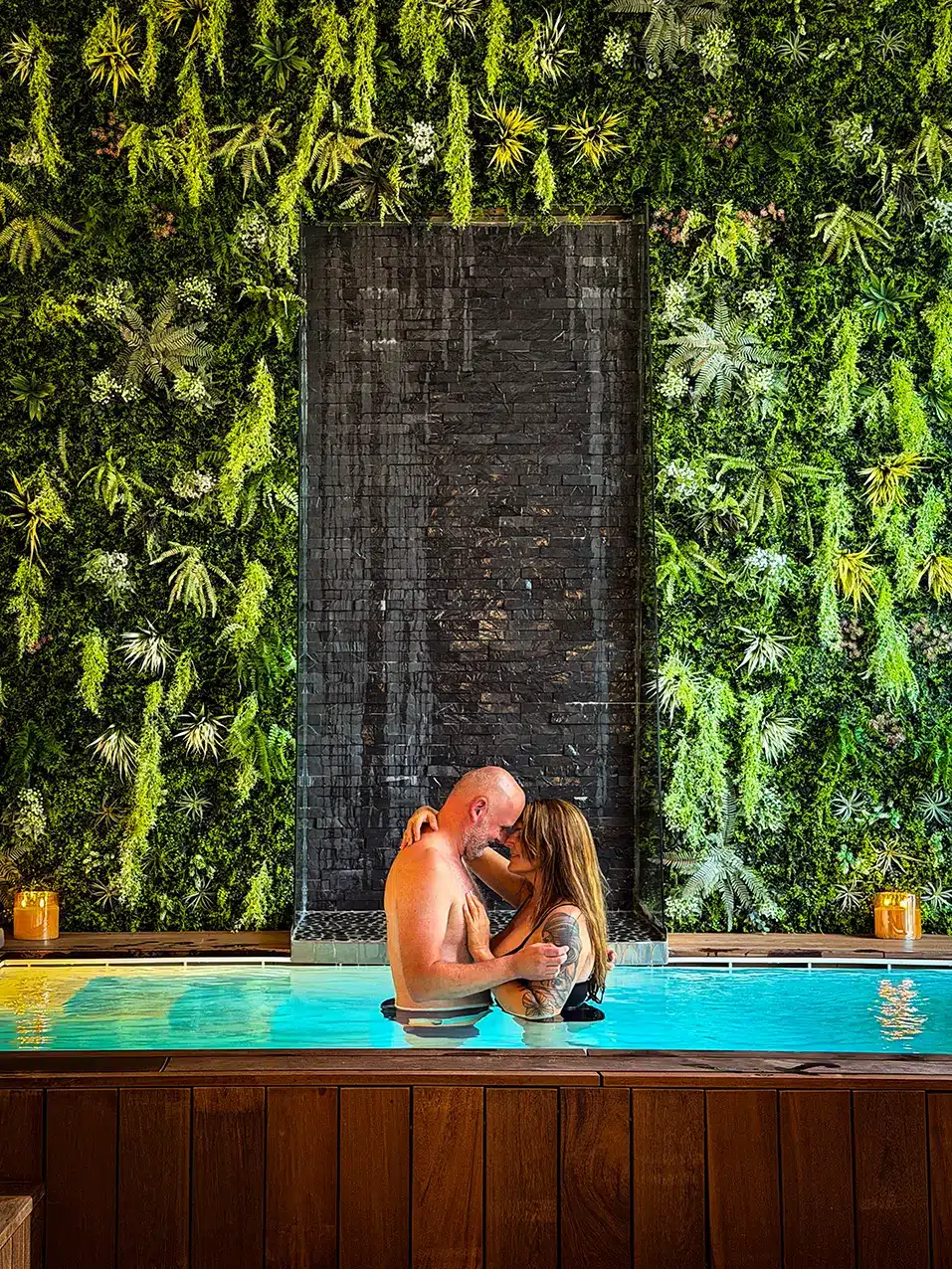 Piscine intérieure privative bordée d’un mur végétalisé